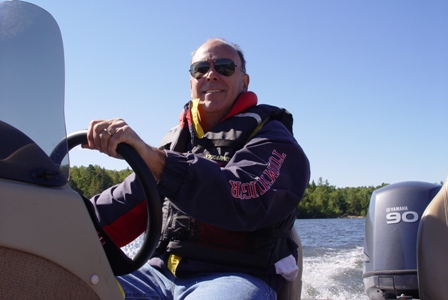 driving Lund boat wearing PFD