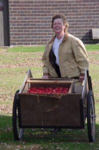 Mary Brazeau Brown with a cart of cranberries