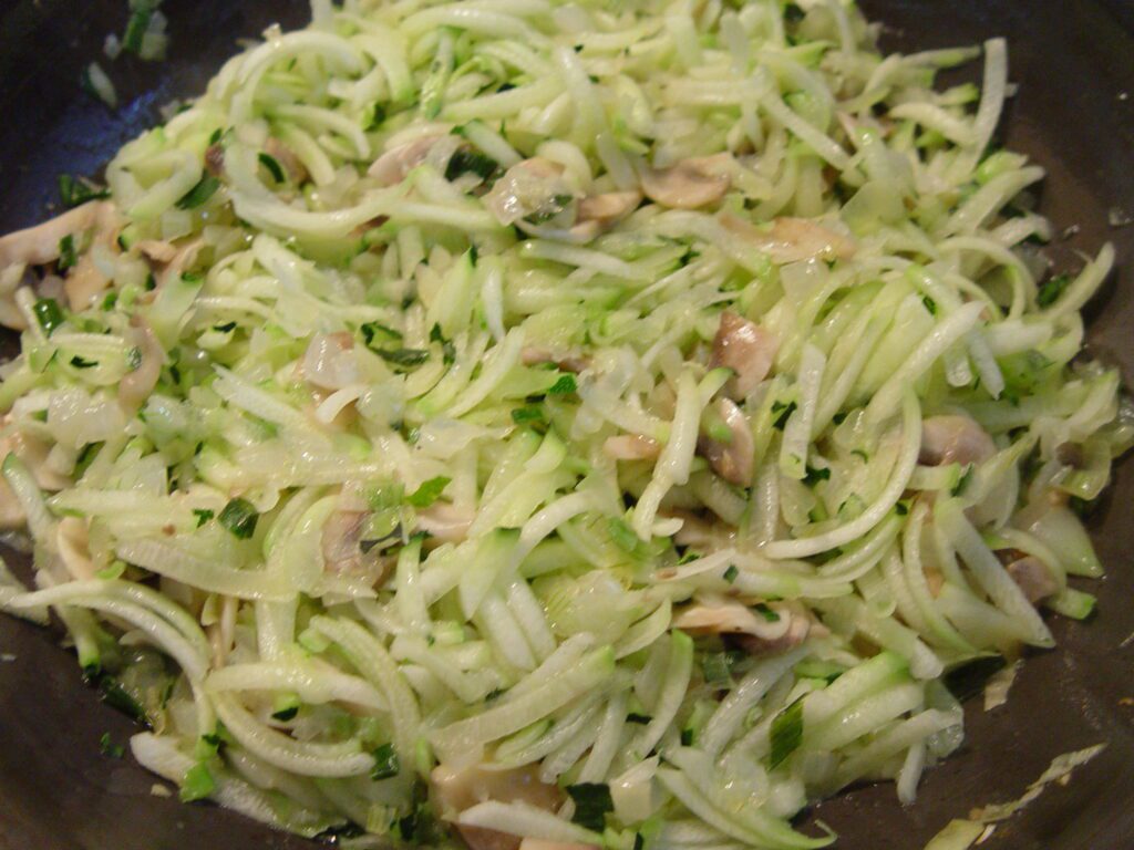 shredded zucchini in pan