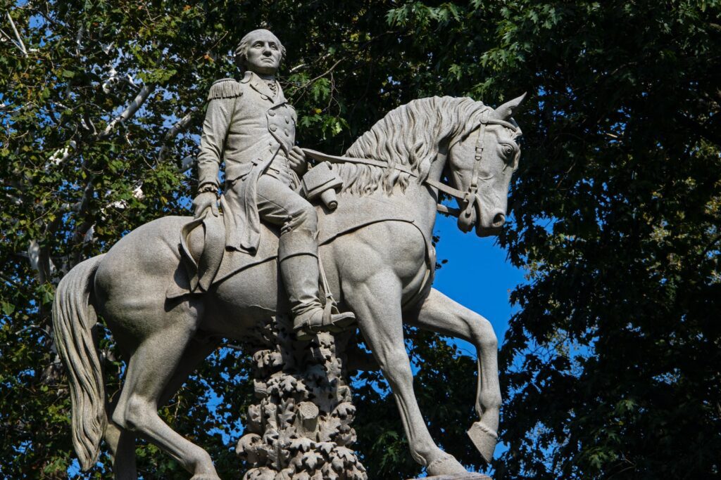 a statue of a man riding on the back of a white horse